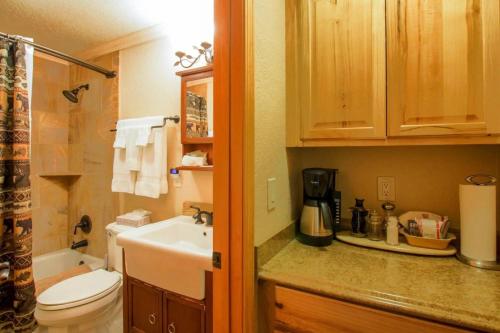 a small bathroom with a sink and a toilet at Yellowstone Gateway Inn in Gardiner