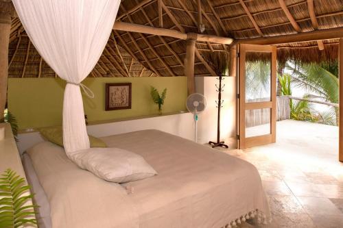 a bedroom with a bed in a room at Casa Mar Beachfront Jungle Villa in Palapa Ganesh in Sayulita