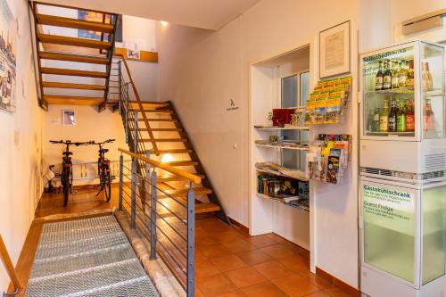 a room with a staircase and a refrigerator at Boutique Hotel am Schillerplatz in Dresden