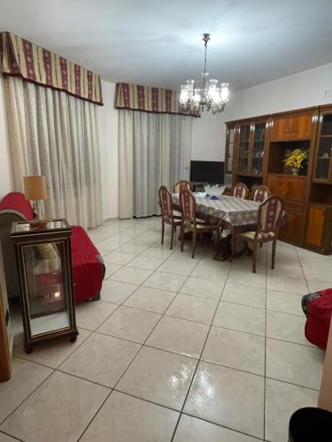 a living room with a table and chairs and a dining room at Casa San Francesco in Mondragone