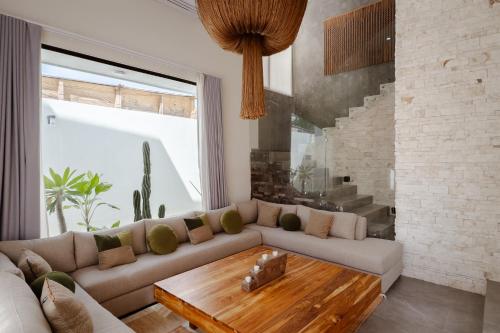 a living room with a couch and a coffee table at Casa Cactus Luxury Villa in Bacalar