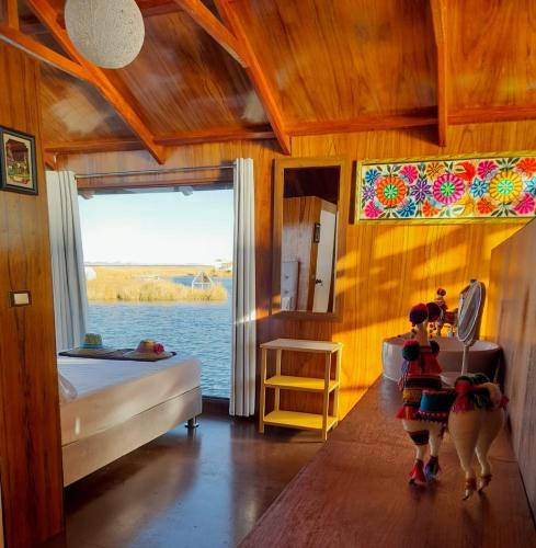 a bedroom with a bed and a view of the water at Titicaca Magical Lodge Peru in Puno