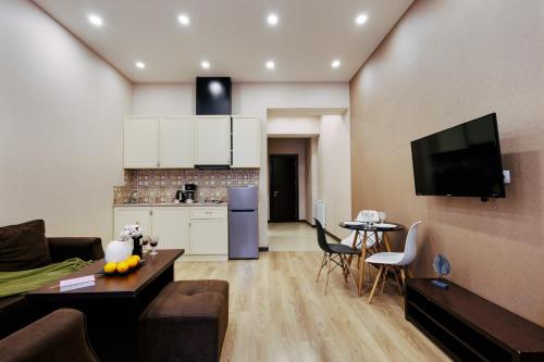 a living room with a couch and a table and a kitchen at Residence North Avenue, Teryan 8. 14 2 in Yerevan