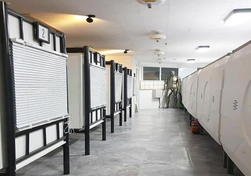 a hallway with a row of stalls in a building at Multi24 멀티 24 hours multi room motel hotel guest house B in Incheon