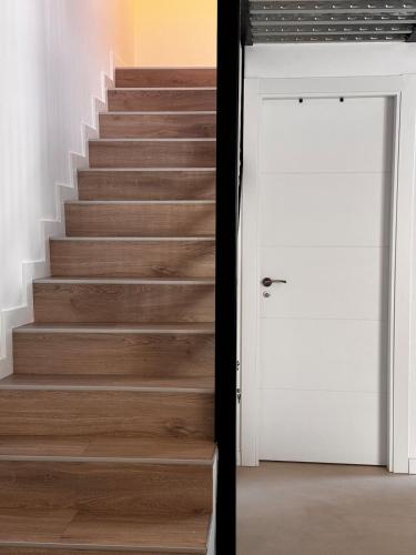 a set of stairs with a white door at VUT La Casa de la Vega in El Barraco