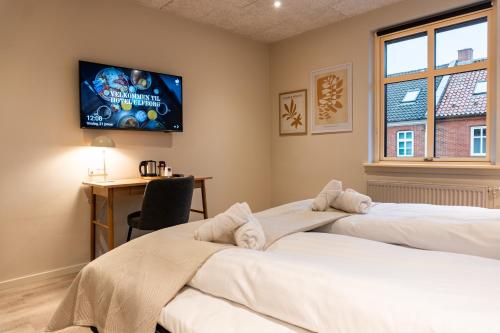 Postel nebo postele na pokoji v ubytování Hotel Ulfborg