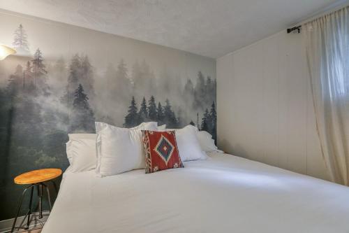 a bedroom with a large bed with a painting on the wall at Moose Suite 1King Bed 1Queen Sofa bed + Hot Tub in Gatlinburg