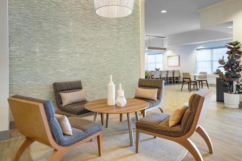 a living room with chairs and a table and a dining room at Residence Inn Tampa Westshore Airport in Tampa