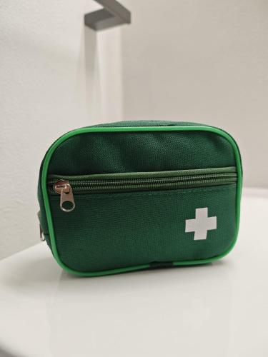 a green bag sitting on a white surface with at Dimora Alessandrina in Alessandria
