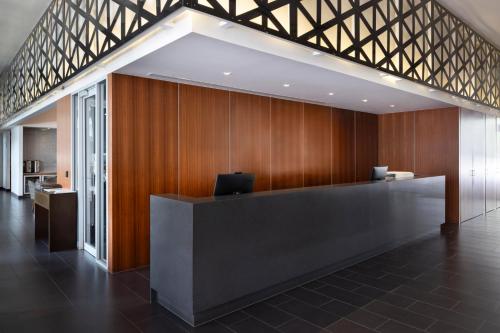 a lobby with a reception desk in a building at The Sebel Melbourne Kew in Melbourne