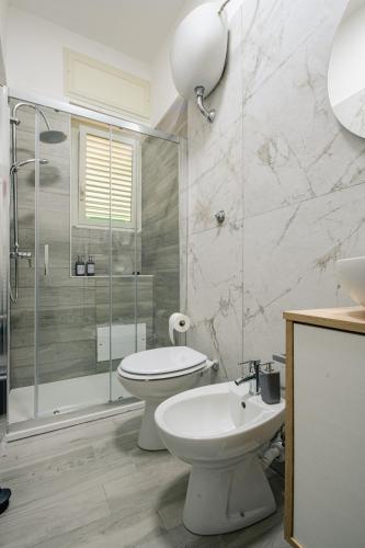 a bathroom with a toilet and a shower and a sink at Il Dubbio ai Quartieri Spagnoli in Naples