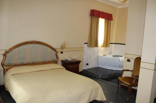 Postel nebo postele na pokoji v ubytování Hotel Ai Sette Nani