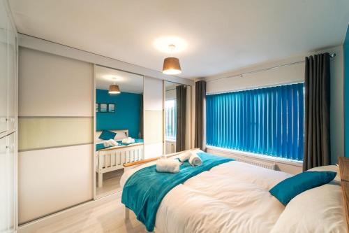 a bedroom with a large bed and a large window at Stylish 4 Bed Henbury Home with Free Parking in Bristol