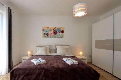Posteľ alebo postele v izbe v ubytovaní Apartments Olive Garden
