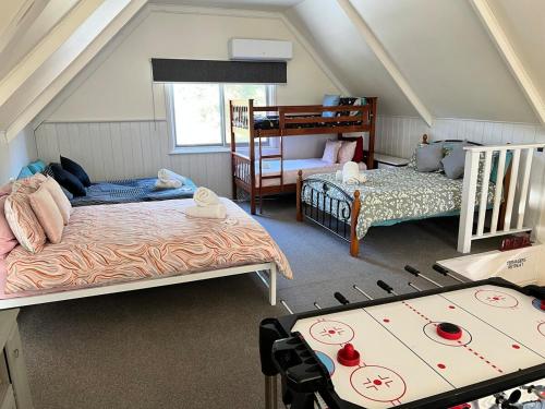 a attic room with two beds and a bunk bed at Countryside Retreat- DS Holiday Home in Carngham