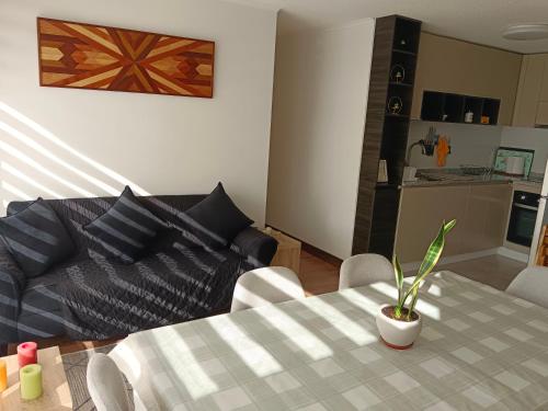 a living room with a table and a couch at Acogedor Dpto en LLanquihue in Llanquihue