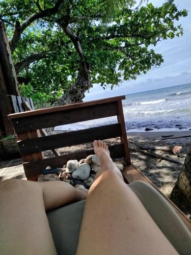 a woman laying on a chair on the beach at Faré TIAREI in Tiarei