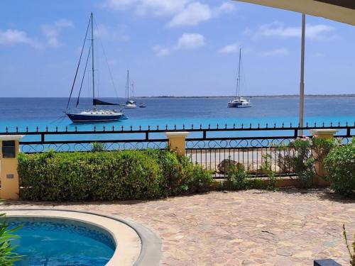 a swimming pool with a view of the ocean at Luxury Oceanfront Elegancia in Kralendijk