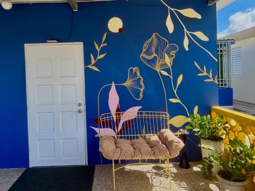 a blue wall with a chair in front of a door at Urban Tropical Oasis in San Juan in San Juan