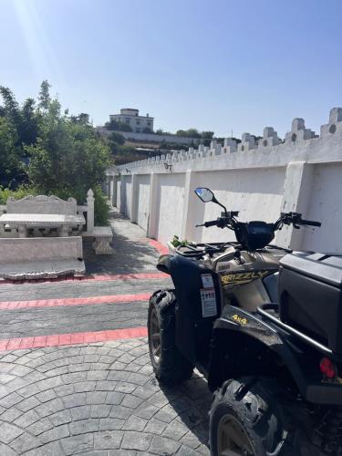 a scooter parked on the side of a street at Charmante Villa à Rmilat Plage in Asilah