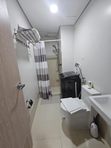 a bathroom with a toilet and a sink and a shower at Style Residences- IML Spaces RM 728 Building B in Iloilo City