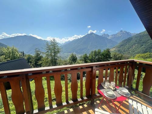 a balcony with a table with plates and wine glasses at Chalet 4 6 Pers Climatisation Proche St Francois in Saint-Martin-sur-le-Chambre