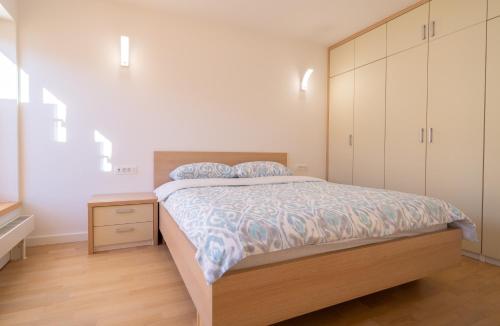 a bedroom with a bed and a dresser and cabinets at Bjelasnica Mountain Retreat in Bjelašnica