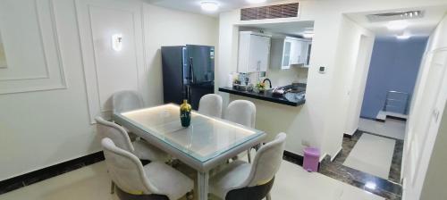 jadalnia ze stołem i krzesłami oraz kuchnia w obiekcie شقة دوبلوكس مستوى فندقى كومبوند بورتو كايرو للعائلات فقط w Kairze