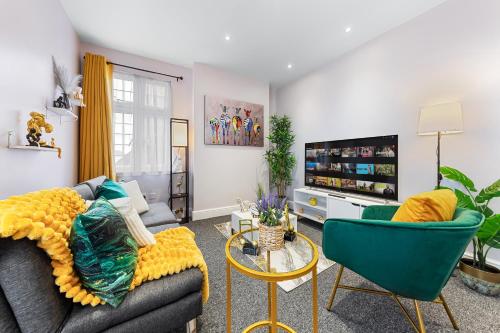 a living room with a couch and two chairs at Spacious London 2-Bed Flat with a King Bed-Save on Long Stays-5 Separate Beds- Parking Available! in Barnet