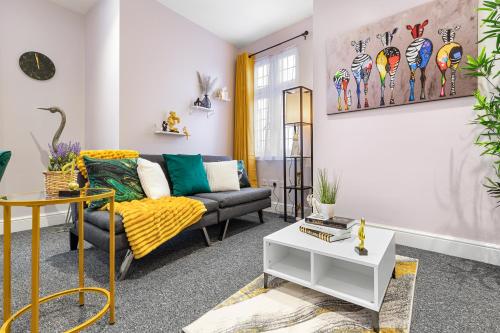 a living room with a couch and a table at Spacious London 2-Bed Flat with a King Bed-Save on Long Stays-5 Separate Beds- Parking Available! in Barnet