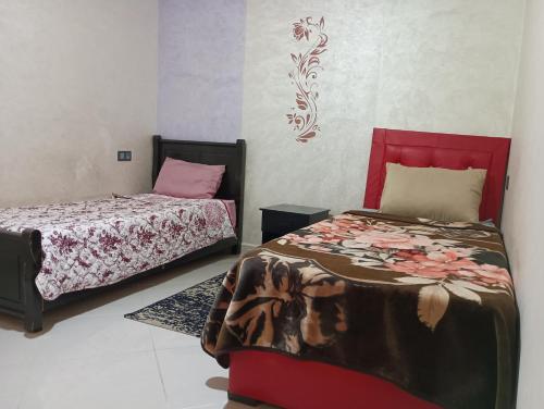 a bedroom with two beds in a room with at Abdelwahab EL KHAYATI in Zemmour Touirza
