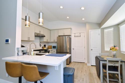 a kitchen with white cabinets and a white counter top at Near the Strip, Smart TVs, WiFi, private garage and backyard in Las Vegas
