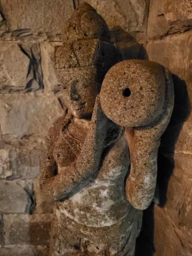 a statue of a person holding a mushroom at 1493 lodge de charme le Santa Maria in St Barthelemy