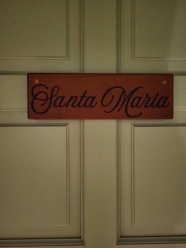 a sign that says santa marica hanging on a wall at 1493 lodge de charme le Santa Maria in St Barthelemy