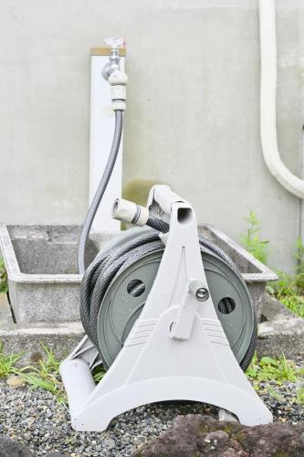 a hose is hooked up to a house at Izukogen 210 in Ito