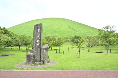 a monument in a field with a hill in the background at Izukogen 210 in Ito