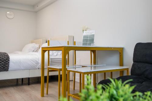 a bedroom with a bed and a table and a couch at Downtown Center Silverstone Tower I and II Long-Term Booking Only Your second home in Vancouver in Vancouver
