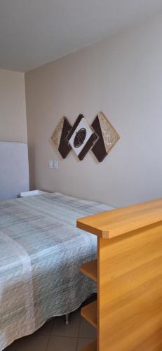 a bedroom with a bed and a wooden table at Eldorado Flat Service apto 601- BL 1 in Caldas Novas