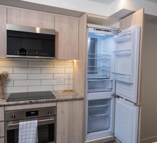 a kitchen with an open refrigerator with its door open at Downtown Center Silverstone Tower I and II Long-Term Booking Only Your second home in Vancouver in Vancouver