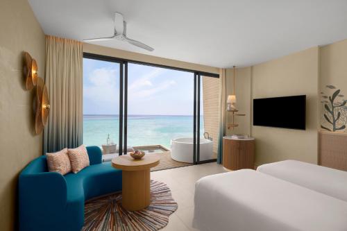 a hotel room with a view of the ocean at Centara Mirage Lagoon Maldives in Nakachchafushi