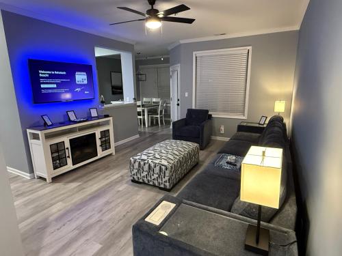 a living room with a couch and a flat screen tv at Modern & Renovated, Dog Friendly, 1st Floor Condo in Rehoboth Beach