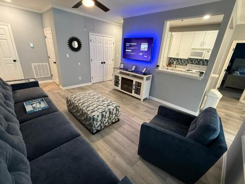 a living room with two couches and a flat screen tv at Modern & Renovated, Dog Friendly, 1st Floor Condo in Rehoboth Beach