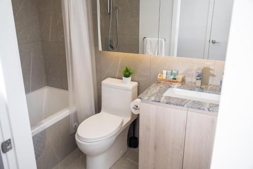 a bathroom with a white toilet and a sink at Downtown Center Silverstone Tower I and II Long-Term Booking Only Your second home in Vancouver in Vancouver
