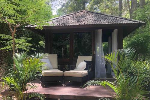 a gazebo with a couch and a chair on a deck at Earthly Retreat - Private Noosa Hinterland Getaway in Doonan