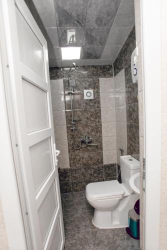 a bathroom with a toilet and a shower at N butik Hotel in Ganja