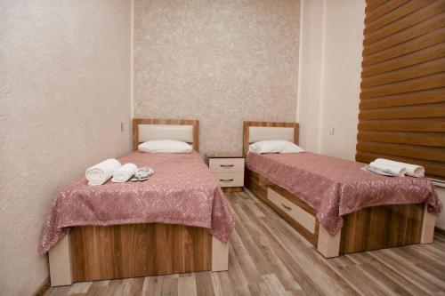 two beds in a room with two beds sidx sidx sidx at N butik Hotel in Ganja