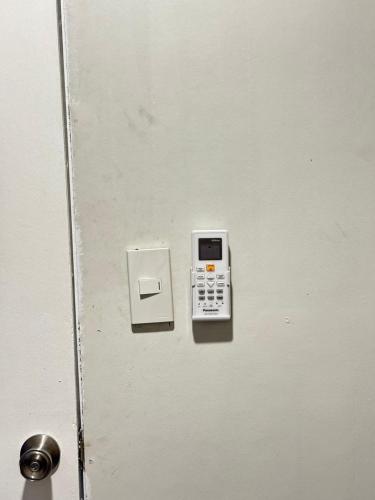 a door with a cell phone on it at Home stay near at Vluna Medical Center Kalayaan Avenue, Philippine Heart Center, East Avenue Medical Hospital, Quezon City in Manila