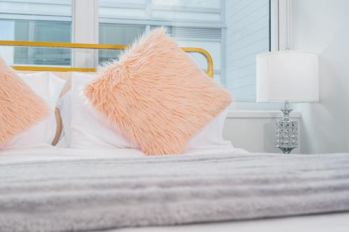 a bed with two pillows and a lamp on it at Downtown Center Silverstone Tower I and II Long-Term Booking Only Your second home in Vancouver in Vancouver