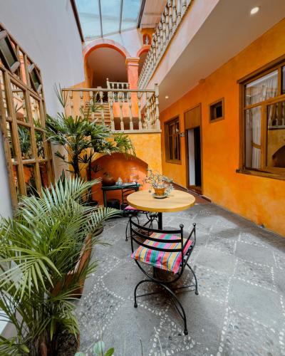 a patio with a table and chairs in a building at Hotel Boutique Casa Montalvo Cuenca in Cuenca