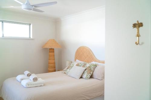 a bedroom with a bed with towels on it at Blueholes Beach Villa - Private Outdoor Space in Kalbarri